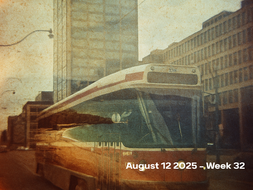 Vintage film photograph of a white and red TTC streetcar stopped in front of Torontoβs iconic bell building