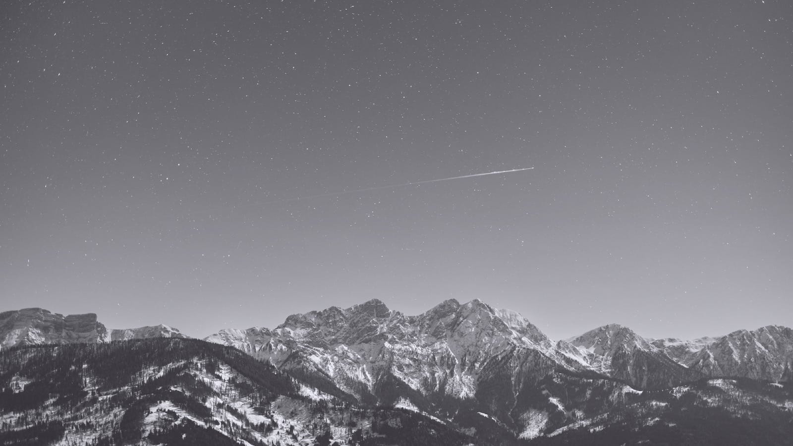 Monochromatic mountain landscape under a starscape, representational of business scaling and fractional marketing leadership for Plate Lunch Collective.