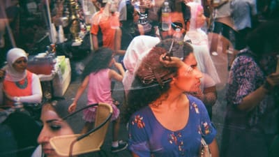 Street crowd with people on phones illustrating social media's shift from connection networks to discovery engines