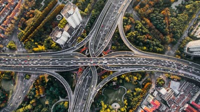 Highway interchange aerial view illustrating AI search traffic pathways and direct traffic flow patterns in digital discovery